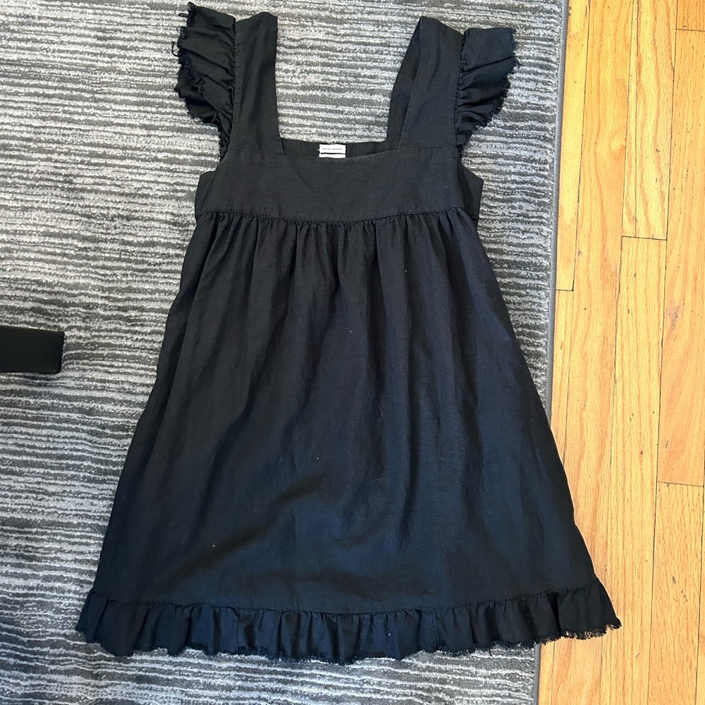Black babydoll dress with fringe on sleeve and bottom